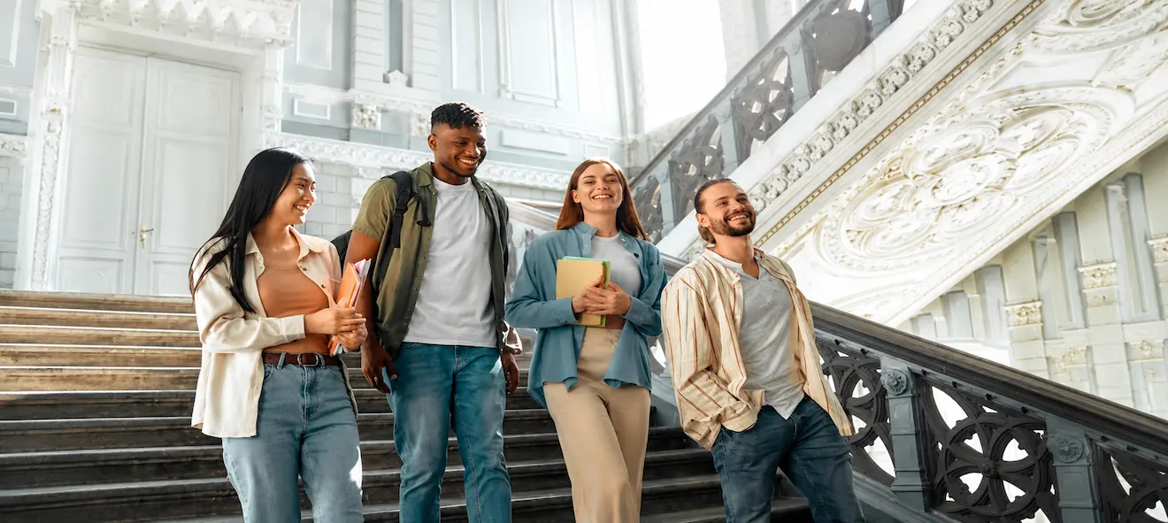 A group of study abroad students walk down a staircase