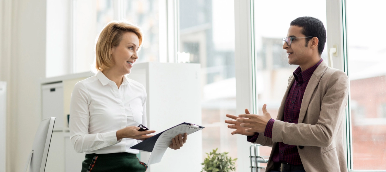 Two Business People Having Discussion In The Office