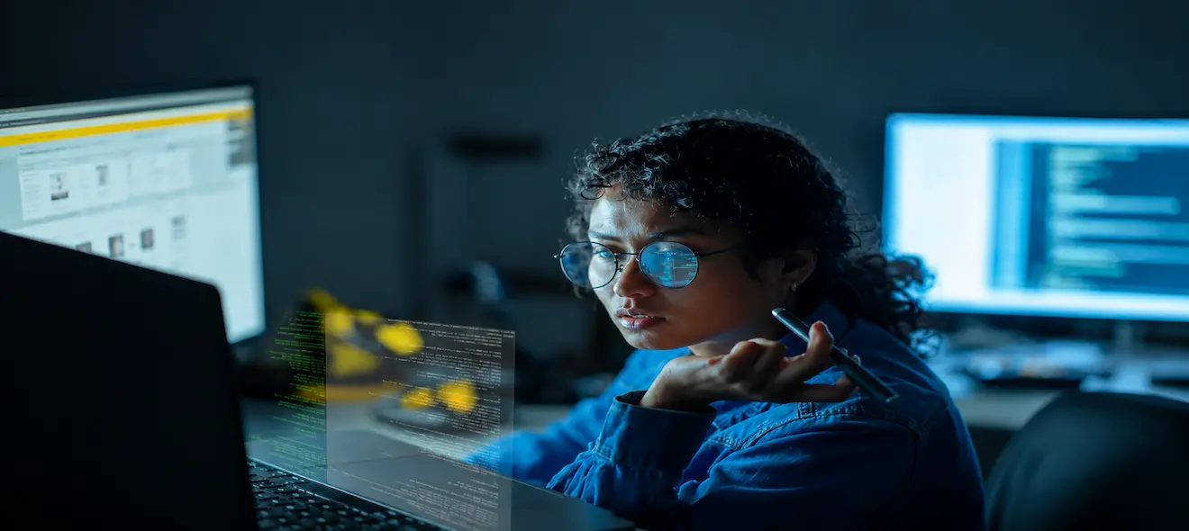 A data scientist looks at data on a computer